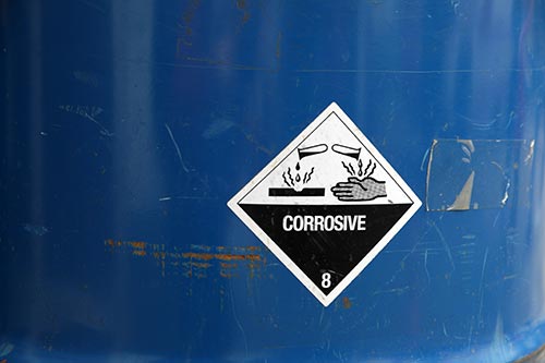 Technician in a mask smiles, breathing easy with GMG’s air quality standards