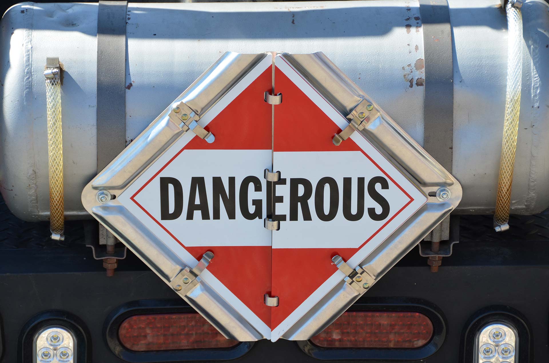 Technician spray painting car with GMG's EHS-compliant collision repair solutions