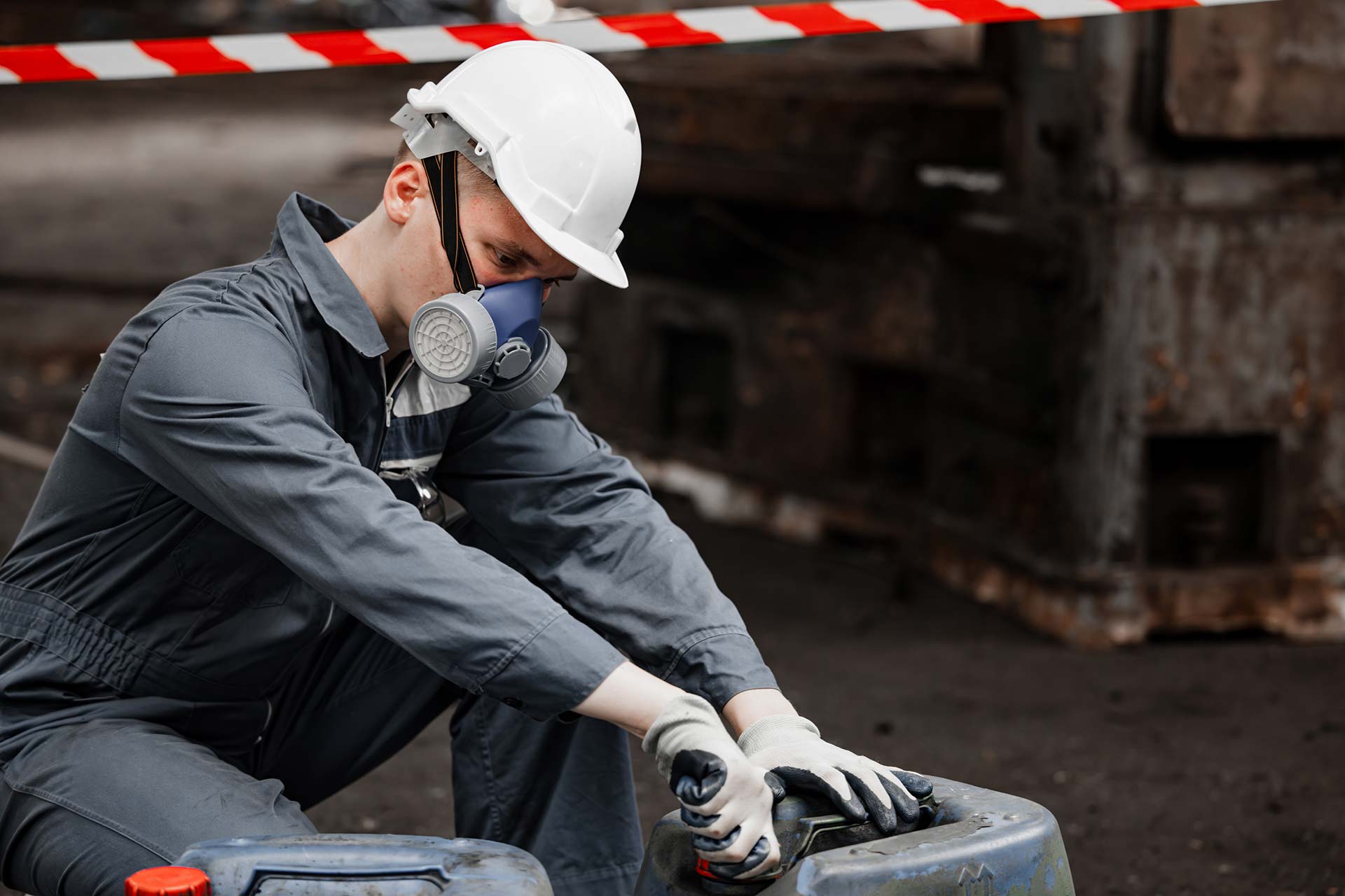 Technician spray painting car with GMG's EHS-compliant collision repair solutions
