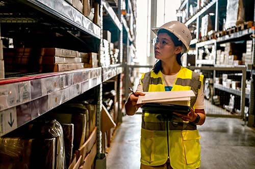Technician in a mask smiles, breathing easy with GMG’s air quality standards