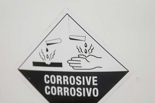 Technician in a mask smiles, breathing easy with GMG’s air quality standards