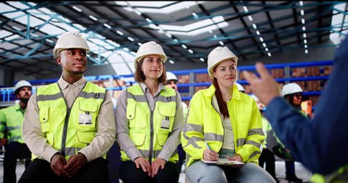 Mechanic checks car undercarriage in GMG-compliant noise-controlled workshop