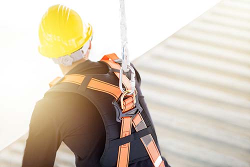 Technician in a mask smiles, breathing easy with GMG’s air quality standards
