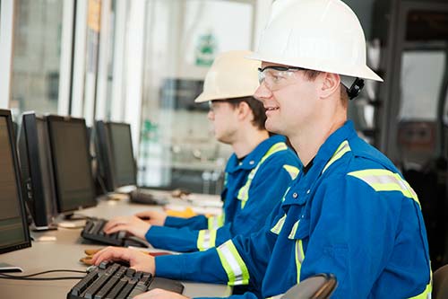Technician in a mask smiles, breathing easy with GMG’s air quality standards