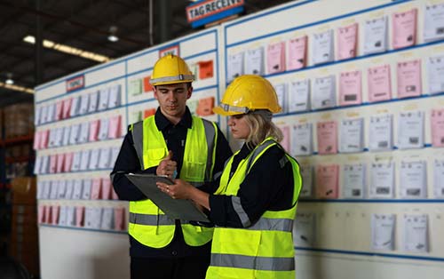 Technician in a mask smiles, breathing easy with GMG’s air quality standards