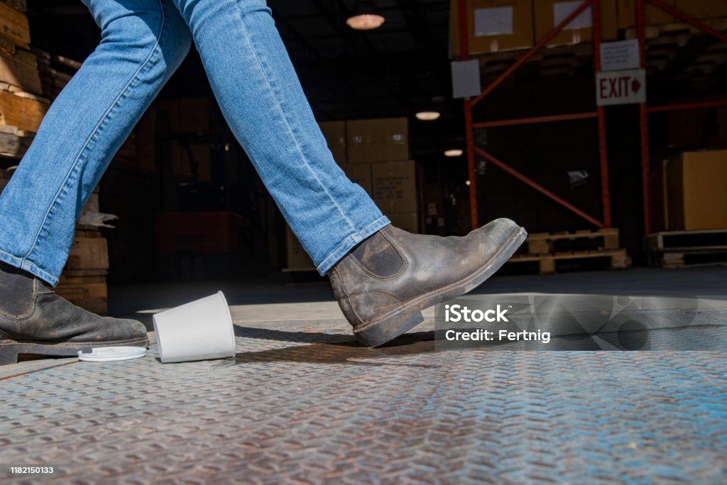 Mechanic checks car undercarriage in GMG-compliant noise-controlled workshop