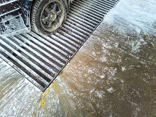 Technician in a mask smiles, breathing easy with GMG’s air quality standards