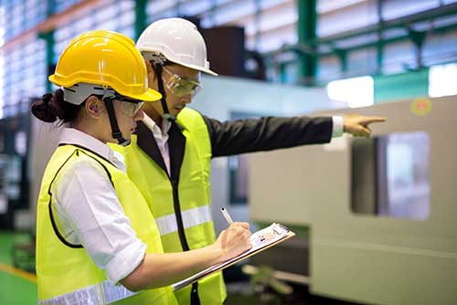 Technician in a mask smiles, breathing easy with GMG’s air quality standards