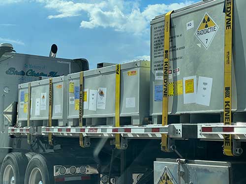 Technician in a mask smiles, breathing easy with GMG’s air quality standards