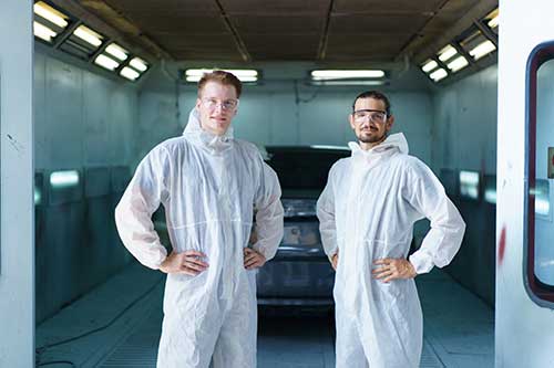 EHS-trained welder practicing fire prevention in a collision repair shop