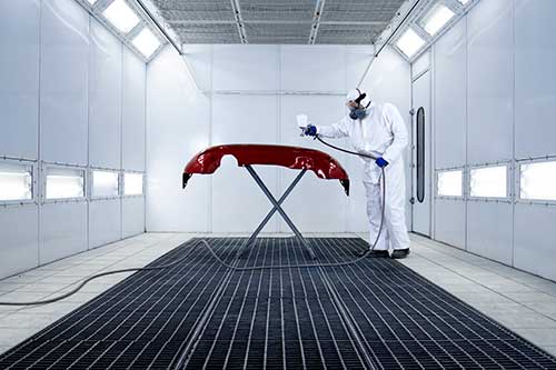 Technician in a mask smiles, breathing easy with GMG’s air quality standards