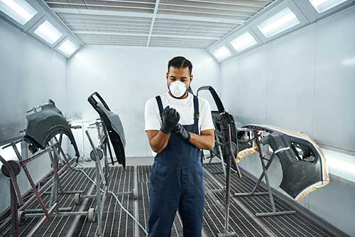 Technician in a mask smiles, breathing easy with GMG’s air quality standards