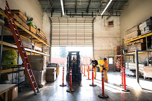 EHS-trained welder practicing fire prevention in a collision repair shop