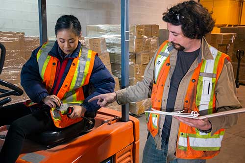 Mechanic checks car undercarriage in GMG-compliant noise-controlled workshop