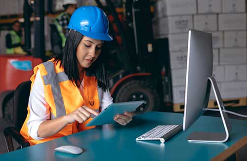 Technician in a mask smiles, breathing easy with GMG’s air quality standards
