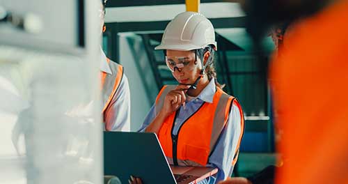 Technician in a mask smiles, breathing easy with GMG’s air quality standards
