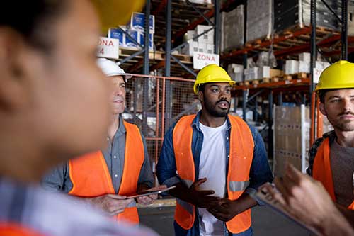 Technician in a mask smiles, breathing easy with GMG’s air quality standards