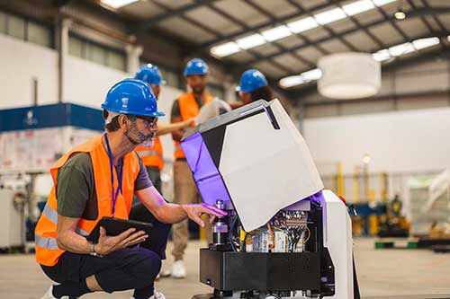 Technician in a mask smiles, breathing easy with GMG’s air quality standards
