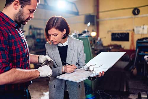 Technician in a mask smiles, breathing easy with GMG’s air quality standards