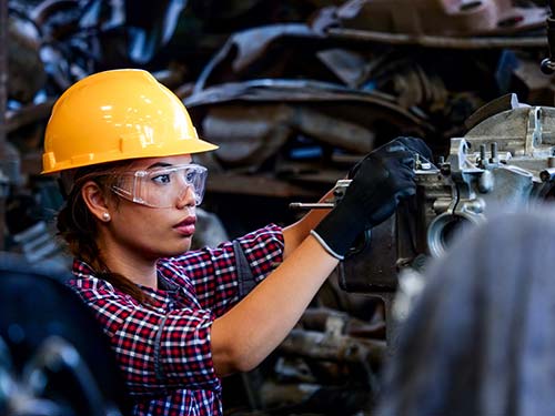 Mechanic checks car undercarriage in GMG-compliant noise-controlled workshop