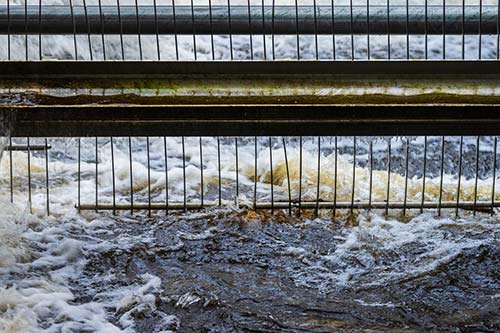 Technician in a mask smiles, breathing easy with GMG’s air quality standards