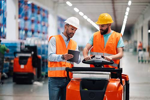 Technician in a mask smiles, breathing easy with GMG’s air quality standards