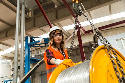 Technician in a mask smiles, breathing easy with GMG’s air quality standards