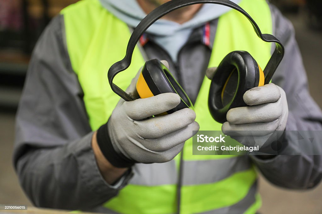 Mechanic checks car undercarriage in GMG-compliant noise-controlled workshop