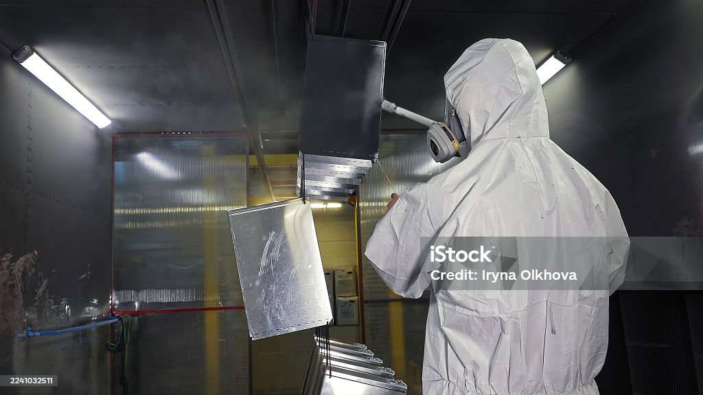 Technician in a mask smiles, breathing easy with GMG’s air quality standards