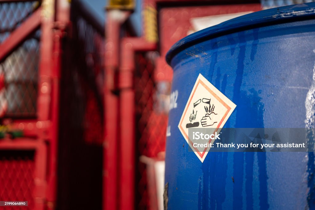 Mechanic responsibly refilling fluids, mindful of GMG's hazardous material protocols