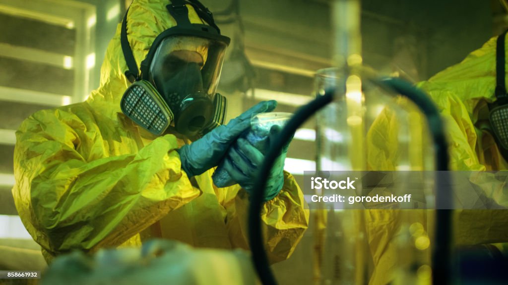 Mechanic responsibly refilling fluids, mindful of GMG's hazardous material protocols