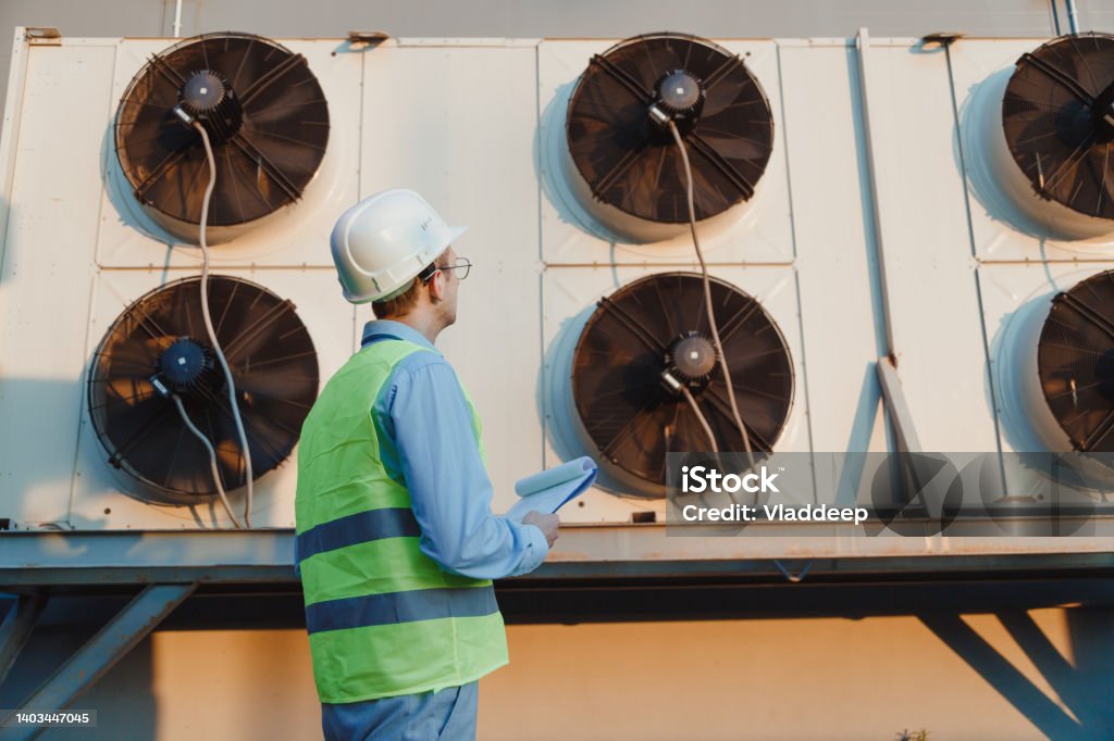 Technician in a mask smiles, breathing easy with GMG’s air quality standards