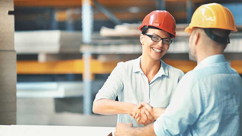 Technician in a mask smiles, breathing easy with GMG’s air quality standards