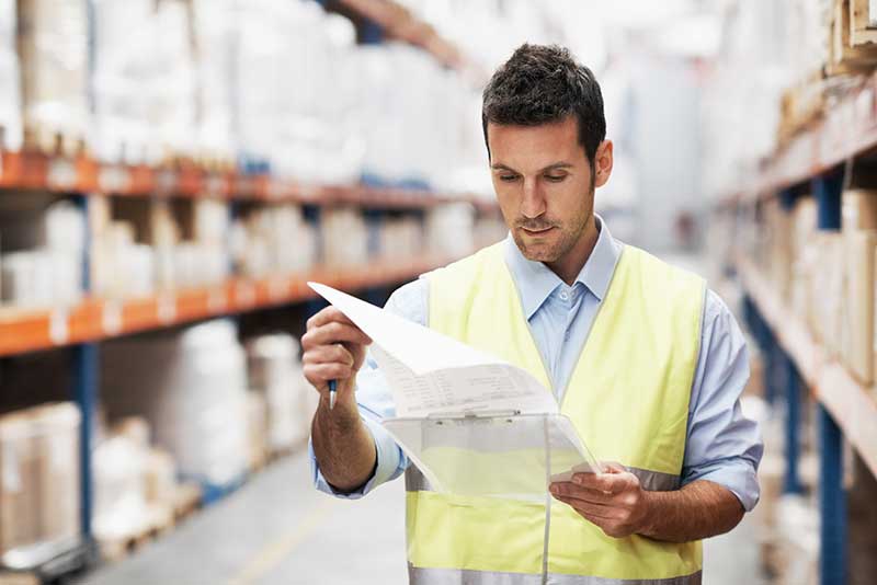 Mechanic checks car undercarriage in GMG-compliant noise-controlled workshop