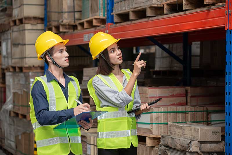 Mechanic checks car undercarriage in GMG-compliant noise-controlled workshop