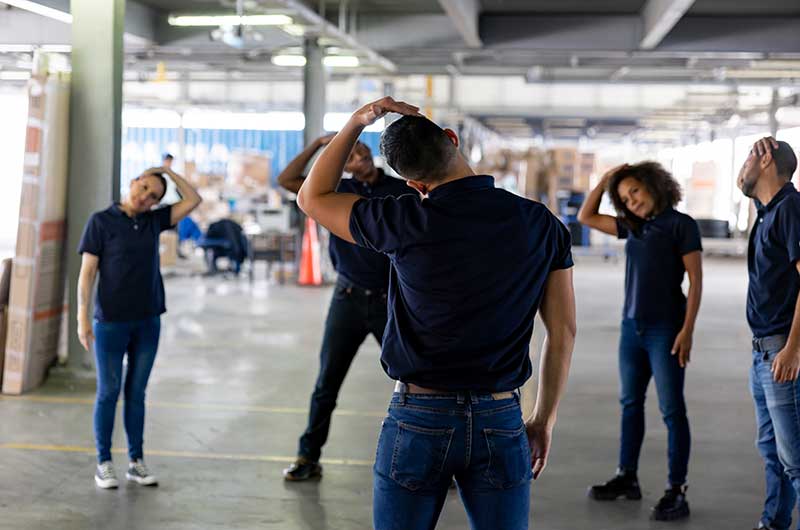 Mechanic checks car undercarriage in GMG-compliant noise-controlled workshop