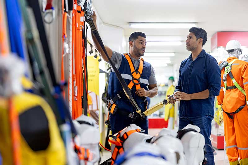 Mechanic checks car undercarriage in GMG-compliant noise-controlled workshop