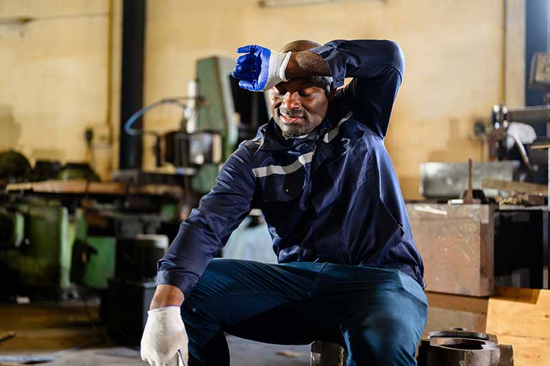 EHS-trained welder practicing fire prevention in a collision repair shop