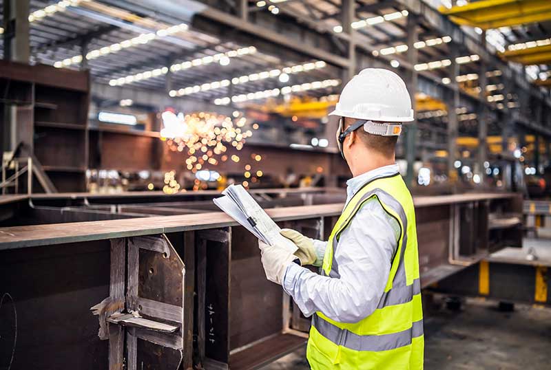 Technician in a mask smiles, breathing easy with GMG’s air quality standards