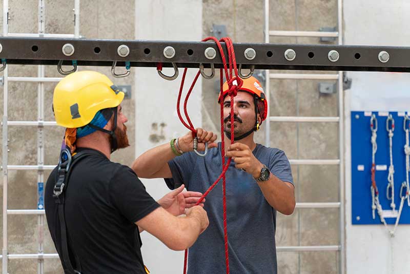 Technician in a mask smiles, breathing easy with GMG’s air quality standards