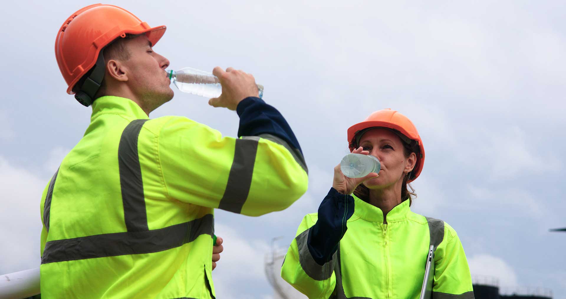 Technician spray painting car with GMG's EHS-compliant collision repair solutions