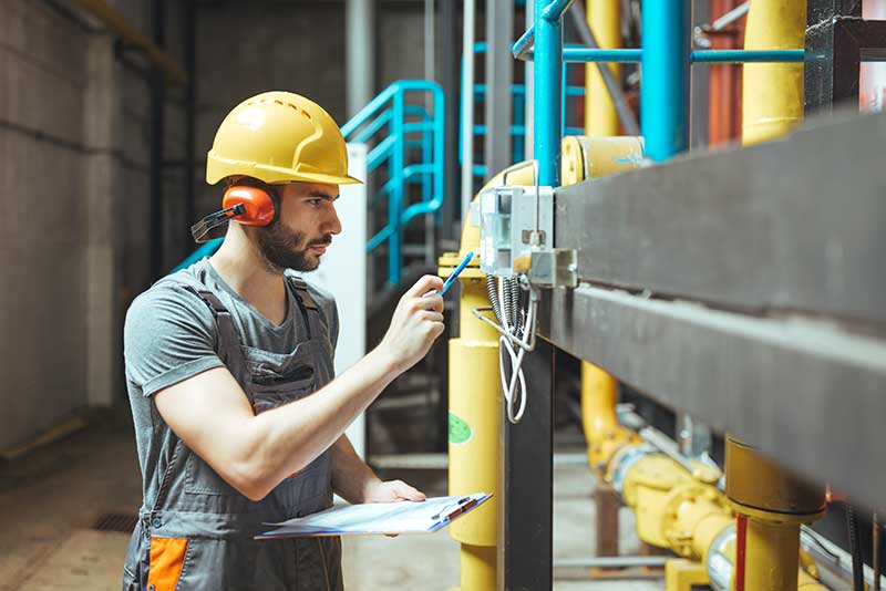 EHS-trained welder practicing fire prevention in a collision repair shop