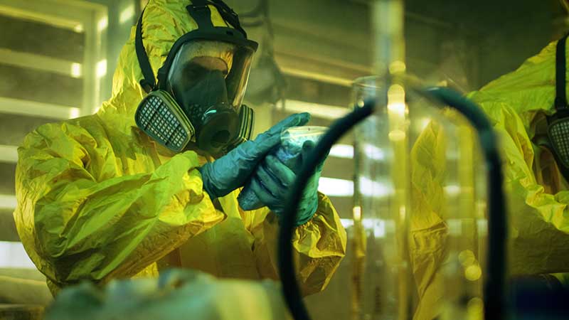 Mechanic responsibly refilling fluids, mindful of GMG's hazardous material protocols