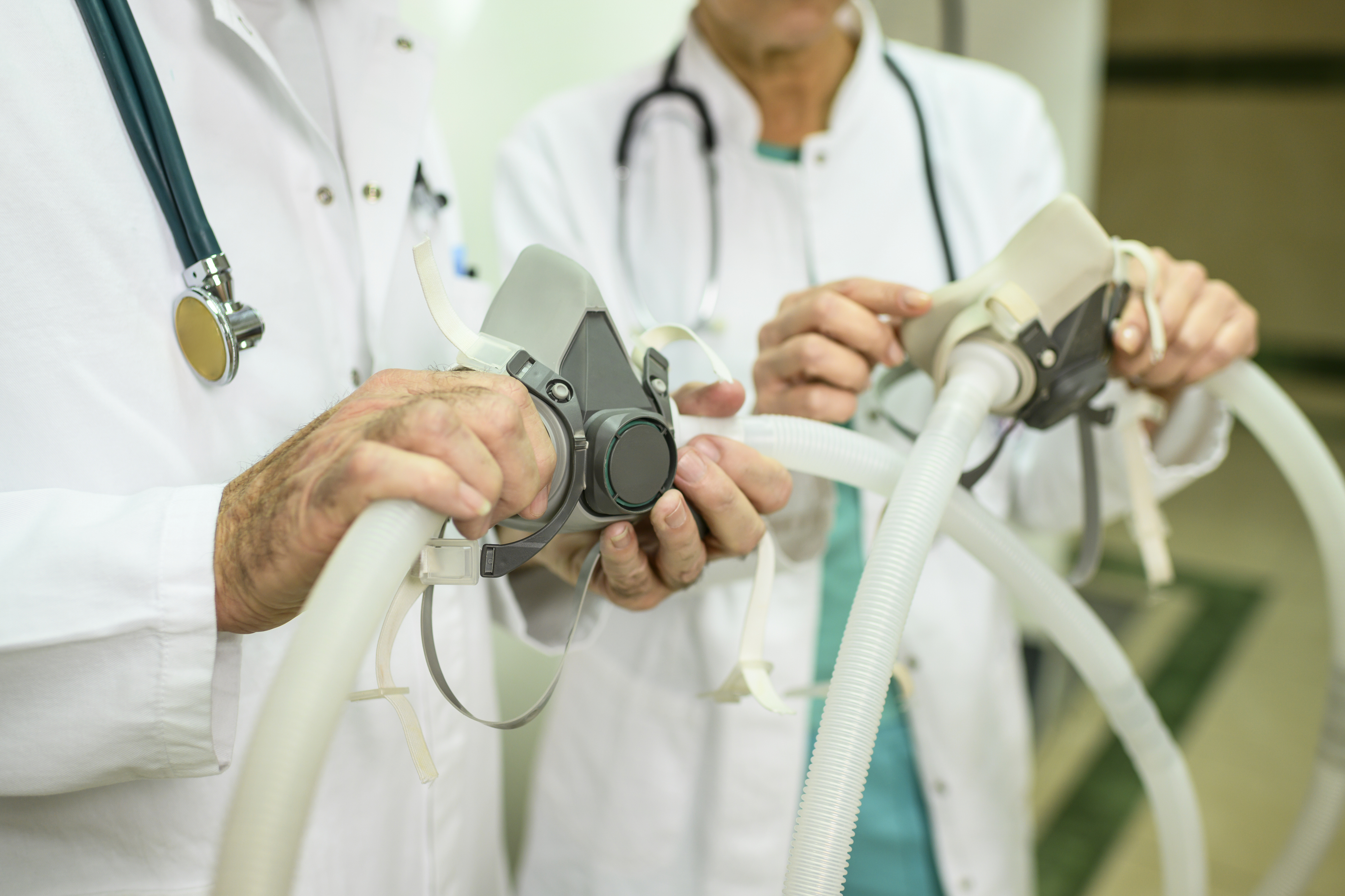 Technician spray painting car with GMG's EHS-compliant collision repair solutions