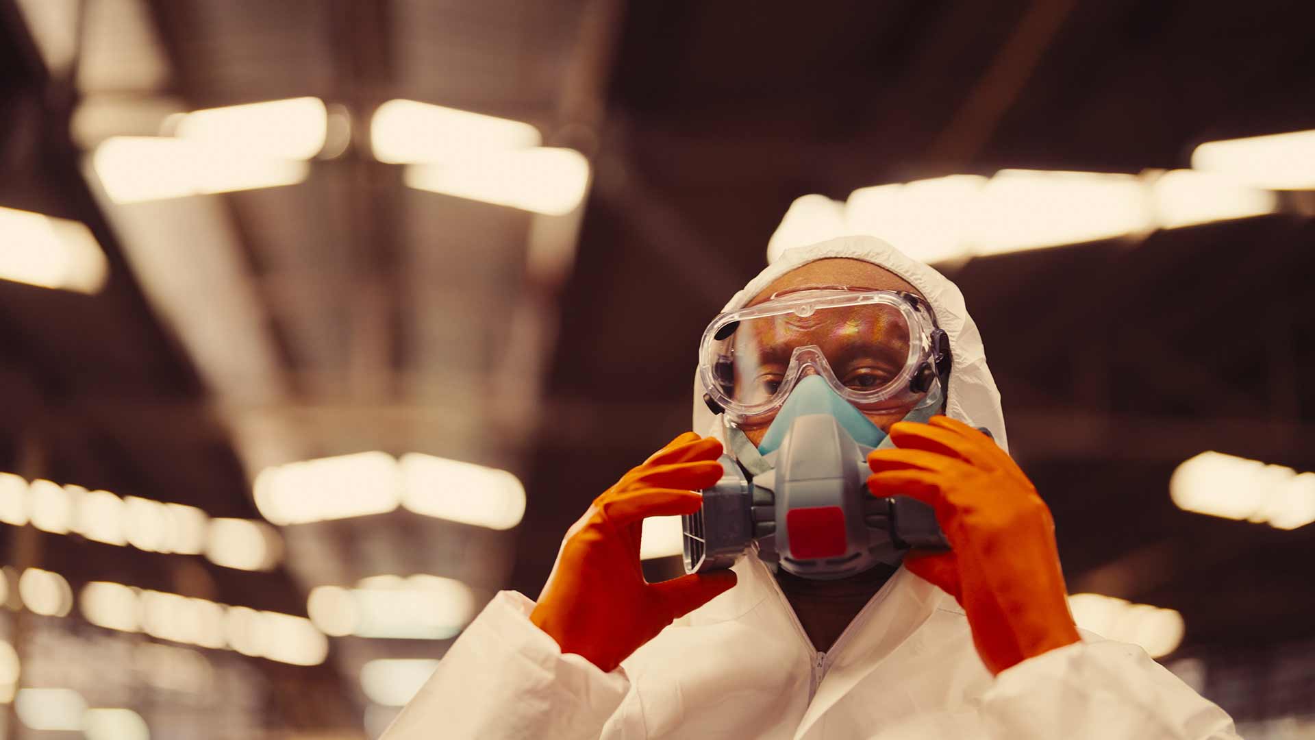 Technician spray painting car with GMG's EHS-compliant collision repair solutions