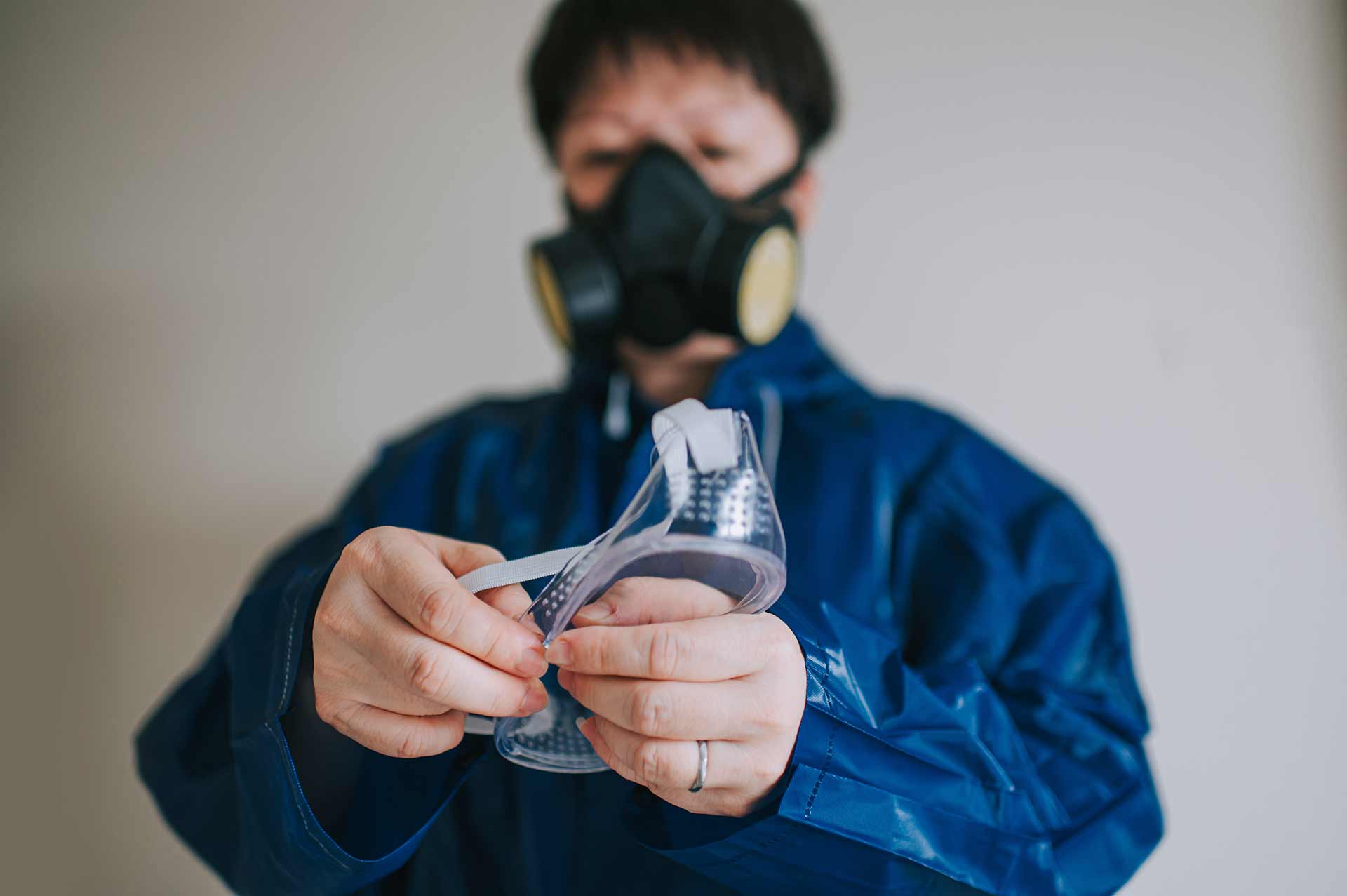 Technician spray painting car with GMG's EHS-compliant collision repair solutions