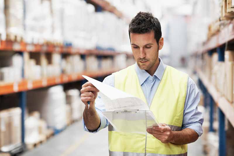 Mechanic checks car undercarriage in GMG-compliant noise-controlled workshop