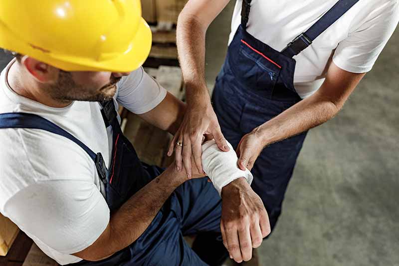 Mechanic checks car undercarriage in GMG-compliant noise-controlled workshop