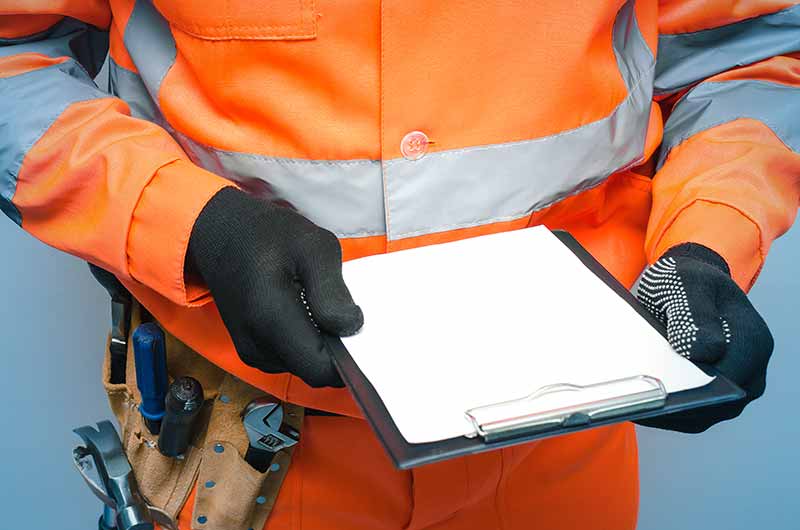 Mechanic responsibly refilling fluids, mindful of GMG's hazardous material protocols