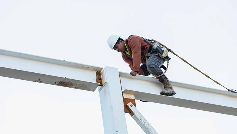 EHS-trained welder practicing fire prevention in a collision repair shop